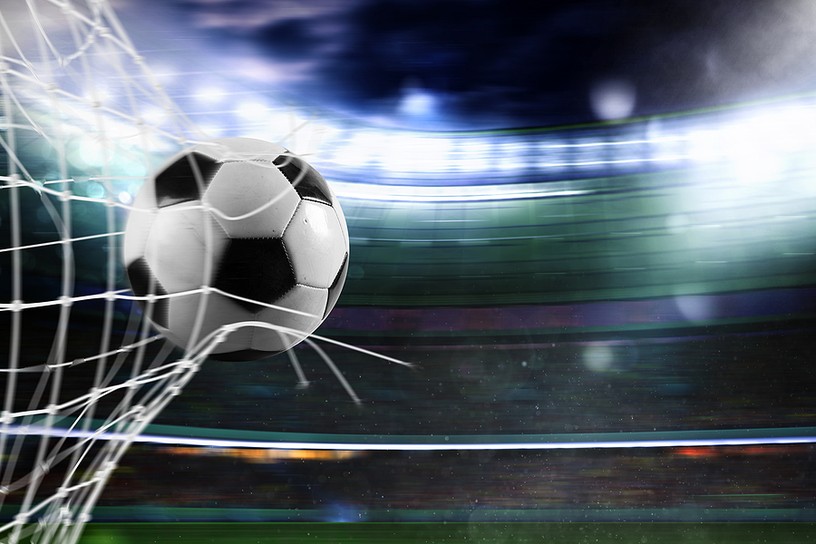 Football Breaking Net in Blurred Stadium
