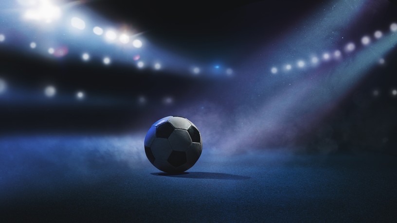 Football in Stadium Under Spotlight