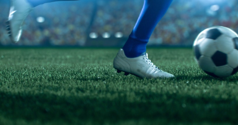 White Boot of Footballer with Blue Sock