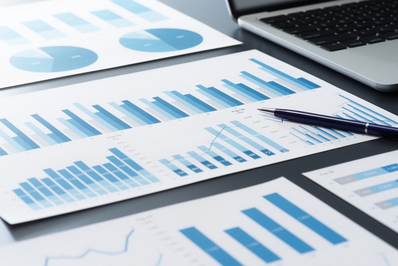 Blue Balance Sheets with Pen and Laptop