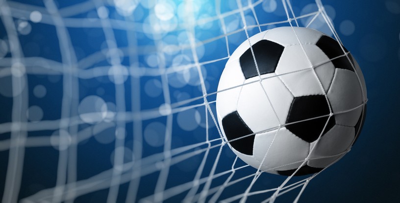 Football and Net Against Blue Background
