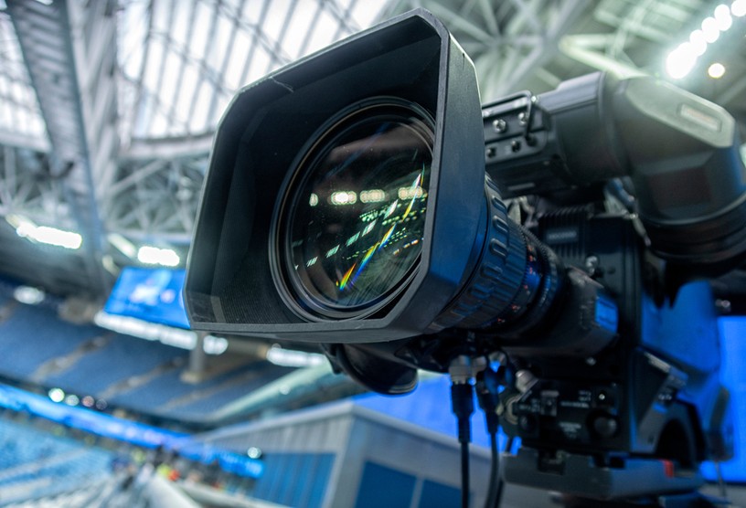 TV Camera in Blue Seated Football Stadium